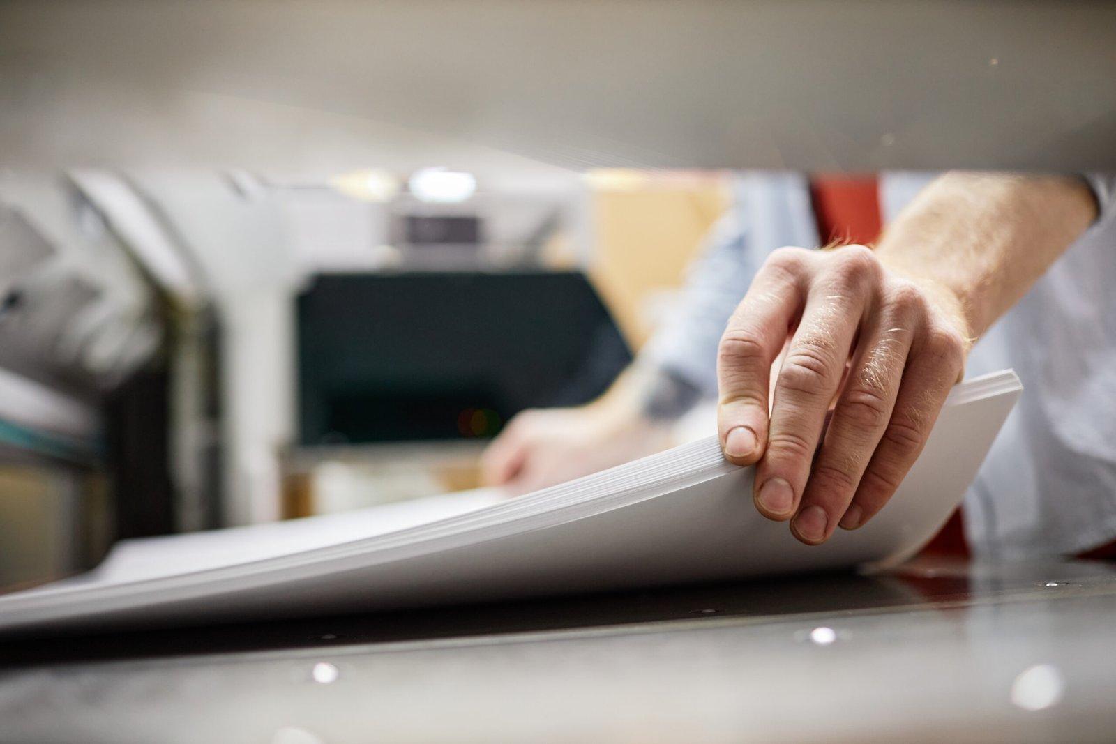 man feeding paper for printing