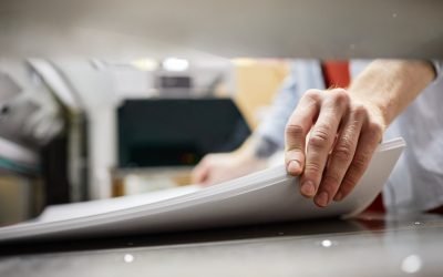 man feeding paper for printing